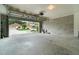 Spacious two car garage with concrete walls and floor, and an automatic door opener at 16828 N Gold Star Ct, Clermont, FL 34714