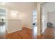 Bright hallway with hardwood floors leading to multiple rooms at 16828 N Gold Star Ct, Clermont, FL 34714