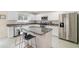 Modern kitchen featuring stainless steel appliances, granite countertops, a breakfast bar, and ample storage space at 16828 N Gold Star Ct, Clermont, FL 34714