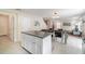 Kitchen featuring an island, dining table, and living room with an open floor plan at 16828 N Gold Star Ct, Clermont, FL 34714
