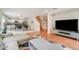 Spacious living room with an open floor plan, modern furnishings, and view of the dining area and kitchen at 16828 N Gold Star Ct, Clermont, FL 34714