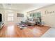 Comfortable living room with modern decor, hardwood floors, ample natural light, and a cozy sectional sofa at 16828 N Gold Star Ct, Clermont, FL 34714