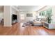 Comfortable living room with modern decor, hardwood floors, ample natural light, and a cozy sectional sofa at 16828 N Gold Star Ct, Clermont, FL 34714