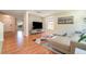 Comfortable living room with modern decor, hardwood floors, ample natural light, and a cozy sectional sofa at 16828 N Gold Star Ct, Clermont, FL 34714