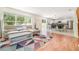 Open-concept living room featuring modern furnishings, a large window, and a view into the adjacent updated kitchen at 16828 N Gold Star Ct, Clermont, FL 34714