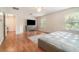 Bright main bedroom boasts a modern dresser and view into the walk-in closet at 16828 N Gold Star Ct, Clermont, FL 34714