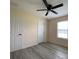 Bedroom featuring neutral walls, gray flooring, a ceiling fan, and a large window at 16910 Sw 27 Avenue, Ocala, FL 34473