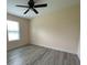 Bedroom showcasing neutral walls, gray flooring, and a bright window at 16910 Sw 27 Avenue, Ocala, FL 34473