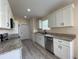 Modern kitchen featuring white cabinets, stainless steel appliances, and granite countertops at 16910 Sw 27 Avenue, Ocala, FL 34473
