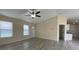Living room showcasing a ceiling fan, a front door, and neutral walls for easy customization at 16910 Sw 27 Avenue, Ocala, FL 34473