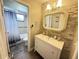 Updated bathroom featuring a vanity, decorative mirror, and shower with blue and gray tiling at 4662 Tiffany Woods Cir, Oviedo, FL 32765