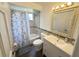 Bathroom with vanity, mirror, and shower with blue butterfly shower curtain at 4662 Tiffany Woods Cir, Oviedo, FL 32765
