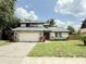 Charming two-story home with a well-maintained lawn and stone accents, with an attached two-car garage at 4662 Tiffany Woods Cir, Oviedo, FL 32765