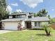 Charming two-story home with a well-maintained lawn and stone accents, with an attached two-car garage at 4662 Tiffany Woods Cir, Oviedo, FL 32765