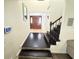 Inviting foyer with hardwood floors, wood staircase, and an elegant front door with lots of natural light at 4662 Tiffany Woods Cir, Oviedo, FL 32765