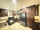 Well-equipped kitchen with dark wood cabinets, granite countertops, and stainless steel appliances at 4662 Tiffany Woods Cir, Oviedo, FL 32765