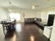 Spacious living room with dark hardwood floors, neutral walls, and lots of natural light from large windows at 4662 Tiffany Woods Cir, Oviedo, FL 32765