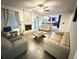 Cozy living room with a stone fireplace, wood floors, and views into the updated kitchen at 4662 Tiffany Woods Cir, Oviedo, FL 32765