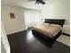 Bright main bedroom with a ceiling fan, window with blinds, and dark wood floors at 4662 Tiffany Woods Cir, Oviedo, FL 32765
