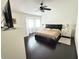 Main bedroom featuring a ceiling fan, large bed, and dark wood flooring at 4662 Tiffany Woods Cir, Oviedo, FL 32765