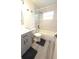 Well-lit bathroom featuring a vanity, toilet, and a shower-tub combination with stylish marble-look tile at 5834 Forest Grove Blvd, Orlando, FL 32808
