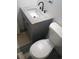 Bathroom features a gray vanity with granite countertop and black faucet, plus a standard white toilet at 5834 Forest Grove Blvd, Orlando, FL 32808