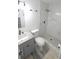 Bright bathroom with a modern vanity, toilet, and a walk-in shower with sleek marble-look tile at 5834 Forest Grove Blvd, Orlando, FL 32808