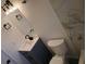 Tidy bathroom includes a tiled wall, a vanity with a black faucet, and a white toilet at 5834 Forest Grove Blvd, Orlando, FL 32808
