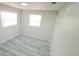 Bright bedroom features fresh paint, new flooring, and two bright windows at 5834 Forest Grove Blvd, Orlando, FL 32808