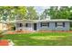 Charming single-story home featuring a well-manicured lawn, tasteful landscaping, and a cozy covered front porch at 5834 Forest Grove Blvd, Orlando, FL 32808