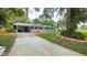 Attractive single-story home boasting a welcoming porch and a driveway leading to a convenient carport at 5834 Forest Grove Blvd, Orlando, FL 32808