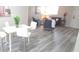 Open-concept living space featuring a dining area and living room with neutral decor and hardwood-style floors at 5834 Forest Grove Blvd, Orlando, FL 32808