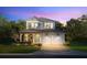 Charming two-story home with a covered porch, a two-car garage, and a beautifully landscaped front yard at 1807 Magnolia Ave, Winter Park, FL 32789