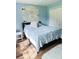 Bright bedroom featuring a large window, hardwood floors, and sliding door closets at 33632 Wesley Rd, Eustis, FL 32736
