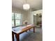 Bright dining room featuring a chandelier and a large window with wood shutters at 33632 Wesley Rd, Eustis, FL 32736