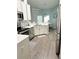 Well-lit kitchen with stainless steel appliances, white cabinets, and a breakfast bar with pendant lighting at 33632 Wesley Rd, Eustis, FL 32736