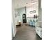 Open-concept kitchen and dining area with modern lighting and a light color palette at 33632 Wesley Rd, Eustis, FL 32736