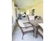Covered patio with wicker seating, ceiling fan and grill, perfect for outdoor gatherings at 33632 Wesley Rd, Eustis, FL 32736
