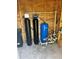 Water filtration system with various tanks and pressure gauges installed in a small shed-like enclosure at 33632 Wesley Rd, Eustis, FL 32736