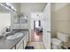 Bathroom vanity and sink with a view into bedroom, toilet, and an open door at 6017 Westgate Dr # 924, Orlando, FL 32835