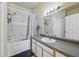 Bathroom featuring a vanity with large mirror, shower/tub, and white tile wall at 6017 Westgate Dr # 924, Orlando, FL 32835