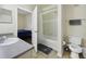 Bathroom with vanity, toilet, and shower/tub combination featuring a curtain and gray towel at 6017 Westgate Dr # 924, Orlando, FL 32835