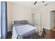 Bedroom with wood-look floors, ceiling fan and a bed with a gray patterned blanket and pillows at 6017 Westgate Dr # 924, Orlando, FL 32835