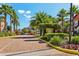 Inviting community entrance lined with palm trees and lush landscaping at 6017 Westgate Dr # 924, Orlando, FL 32835