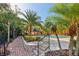 Inviting community pool with lounge chairs, lush landscaping and palm trees, surrounded by manicured grounds at 6017 Westgate Dr # 924, Orlando, FL 32835