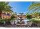 Beautiful community pool and clubhouse surrounded by lush landscaping, planters, and palm trees at 6017 Westgate Dr # 924, Orlando, FL 32835