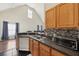Kitchen with wood cabinets, dark countertops, and stainless steel dishwasher, perfect for cooking at 6017 Westgate Dr # 924, Orlando, FL 32835