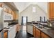 Kitchen featuring a view of the living area, wood cabinets, and stainless steel sink and appliances at 6017 Westgate Dr # 924, Orlando, FL 32835