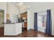 Bright and airy living area flowing into the kitchen with wood floors and natural lighting at 6017 Westgate Dr # 924, Orlando, FL 32835