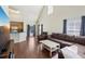 Open-concept living space with a vaulted ceiling, hardwood floors, and a view of the kitchen at 6017 Westgate Dr # 924, Orlando, FL 32835